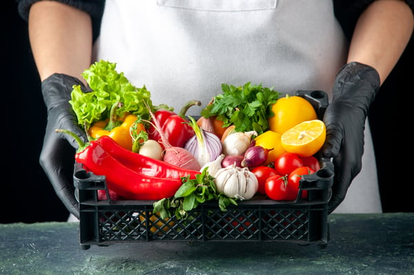 front-view-female-cook-holding-basket-with-fresh-vegetables-on-dark-food-cooking-color-salad-kitchen-cuisine